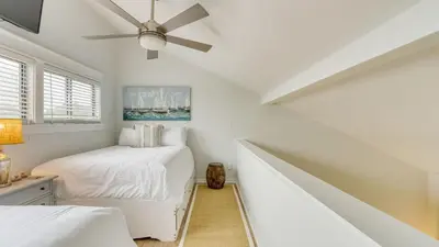 a white bedroom with two beds and a ceiling fan at 2 Condos Steps to Beach Ocean View Heated Pool The Sea Chord Salt Haus in Watersound Beach