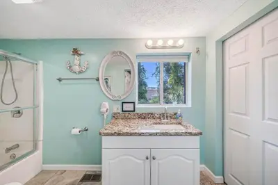 a bathroom with a sink and a mirror at Resort Townhome with Free Golf Cart in Panama City Beach