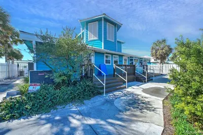 a blue house with stairs in front of it at Resort Townhome with Free Golf Cart in Panama City Beach