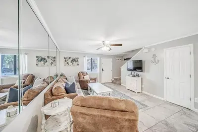a living room with a couch and a table at Resort Townhome with Free Golf Cart in Panama City Beach