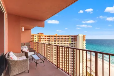 a balcony with chairs and a view of the ocean at Come visit Sophomore! 2BR 2BA Beachfront Condo! Sleeps 5! in Panama City Beach