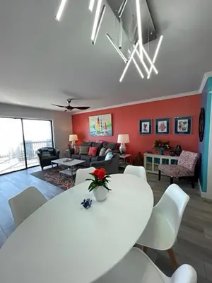 a living room with a white table and chairs at Seagull Villas #3 by Emerald Coast Retreats in Panama City Beach