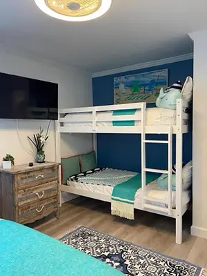 a bedroom with two bunk beds and a dresser at Seagull Villas #3 by Emerald Coast Retreats in Panama City Beach
