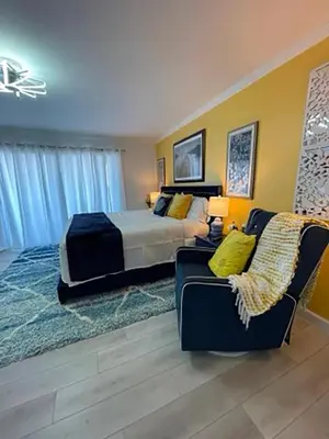 a large bedroom with a bed and a couch at Seagull Villas #3 by Emerald Coast Retreats in Panama City Beach