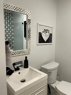 a bathroom with a sink and a toilet and a mirror at Seagull Villas #3 by Emerald Coast Retreats in Panama City Beach