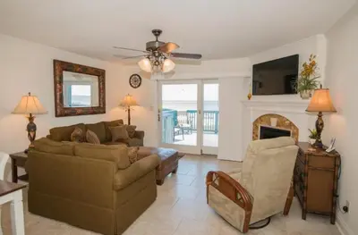 a living room with a couch and a fireplace at Seagull Villas #7 by Emerald Coast Retreats in Panama City Beach