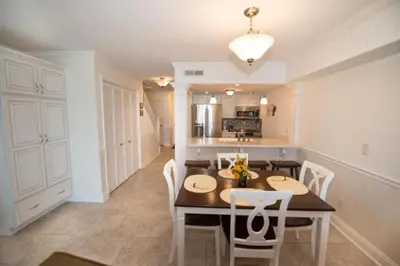 a kitchen and dining room with a table and chairs at Seagull Villas #7 by Emerald Coast Retreats in Panama City Beach