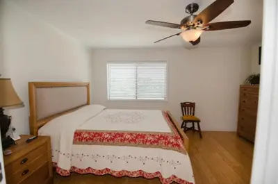a bedroom with a bed and a ceiling fan at Seagull Villas #7 by Emerald Coast Retreats in Panama City Beach