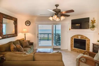 a living room with a couch and a fireplace at Seagull Villas #7 by Emerald Coast Retreats in Panama City Beach
