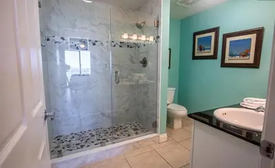 a bathroom with a shower and a sink at Calypso 2-404 by Emerald Coast Retreats in Panama City Beach