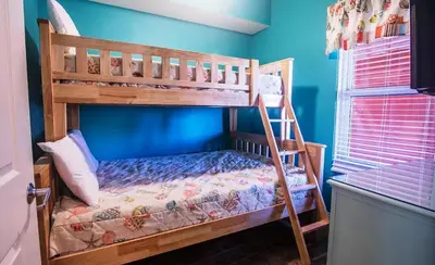a bunk bed with a ladder in a room at Calypso 2-404 by Emerald Coast Retreats in Panama City Beach