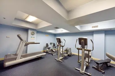 a gym with several tread machines in a room at Calypso 2-404 by Emerald Coast Retreats in Panama City Beach