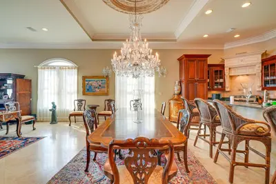 a dining room with a table and chairs and a chandelier at Like No Other in the Panhandle of Florida in Seacrest