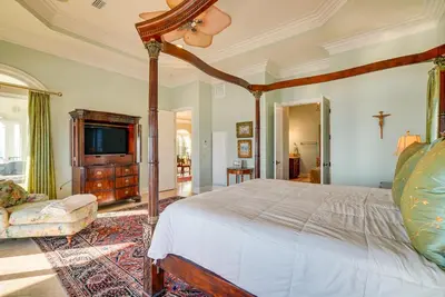 a bedroom with a large bed and a tv at Like No Other in the Panhandle of Florida in Seacrest