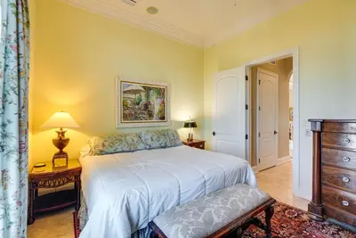 a bedroom with a white bed and a dresser at Like No Other in the Panhandle of Florida in Seacrest