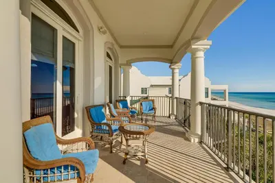 a porch with chairs and a table and the ocean at Like No Other in the Panhandle of Florida in Seacrest