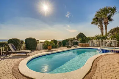a swimming pool with chairs and a fence at Like No Other in the Panhandle of Florida in Seacrest