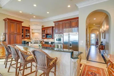 a kitchen with a large island with bar stools at Like No Other in the Panhandle of Florida in Seacrest
