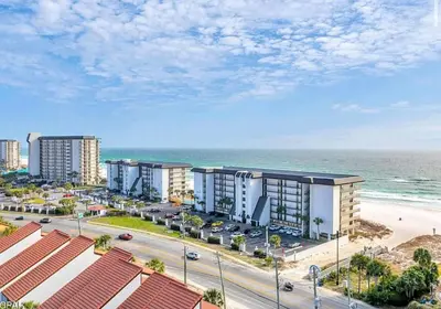 an aerial view of a beach with buildings and the ocean at Sandy Feet Retreat 3 bed 3 bath in Panama City Beach