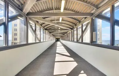 an empty corridor in a building with windows at Sandy Feet Retreat 3 bed 3 bath in Panama City Beach