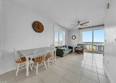 a living room with a table and chairs and a couch at Sandy Feet Retreat 3 bed 3 bath in Panama City Beach