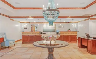 a large living room with a table in the middle at Sandy Feet Retreat 3 bed 3 bath in Panama City Beach