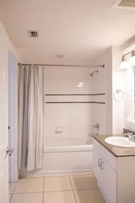 a white bathroom with a tub and a sink at Sandy Feet Retreat 3 bed 3 bath in Panama City Beach