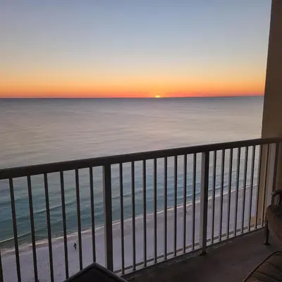 a view of the beach at sunset from a condo balcony at Blue Haven Escape, 2 Bed 2 Bath in Panama City Beach