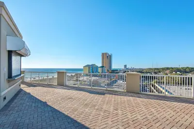 a balcony with a view of the ocean and buildings at Blue Haven Escape, 2 Bed 2 Bath in Panama City Beach