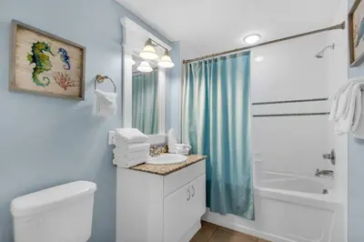 a bathroom with a toilet and a sink and a tub at Blue Haven Escape, 2 Bed 2 Bath in Panama City Beach
