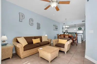 a living room with a couch and chairs and a dining room at Blue Haven Escape, 2 Bed 2 Bath in Panama City Beach