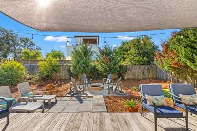 a patio with chairs and a fire pit at Laguna Breeze! Dog-Friendly 4BR Beach Escape for 8 with Coastal Charm! in Panama City Beach