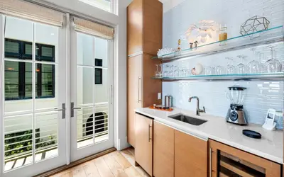 a kitchen with a sink and a window at Sealah in Rosemary Beach