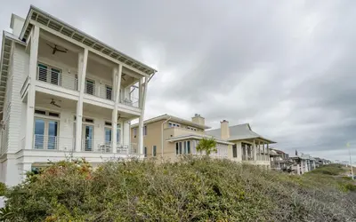 a row of houses on a hill with bushes at Sealah in Rosemary Beach