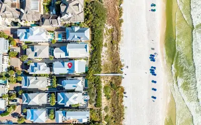 an overhead view of a row of houses next to a beach at Sealah in Rosemary Beach