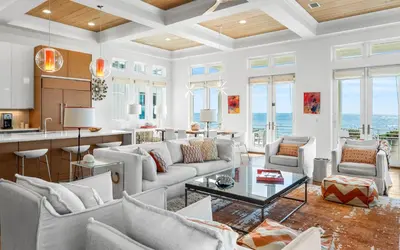 a living room with a couch and a table at Sealah in Rosemary Beach
