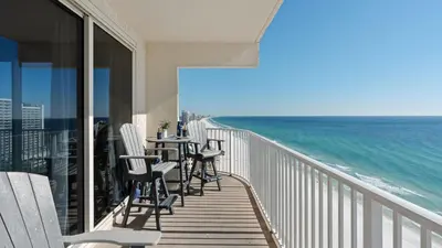 a balcony with chairs and a table and the ocean at Emerald Horizon by AvantStay Beachfront Condo Resort Pool Gulf Balcony Views Near Pier Park Dining in Panama City Beach
