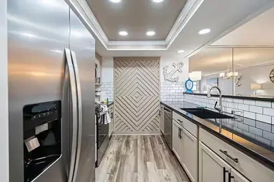 a large kitchen with a stainless steel refrigerator at Moondrifter 205 in Panama City Beach