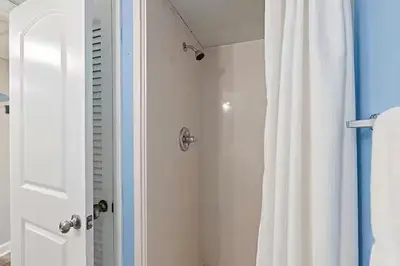 a bathroom with a shower with a shower curtain at Moondrifter 205 in Panama City Beach