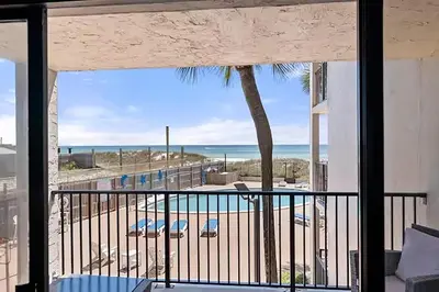 a balcony with a view of the beach and the ocean at Moondrifter 205 in Panama City Beach