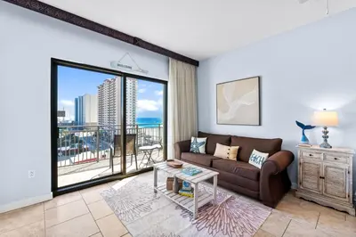 a living room with a couch and a large window at Origin 0933 - Studio King - Sunrise Gulf Views in Panama City Beach