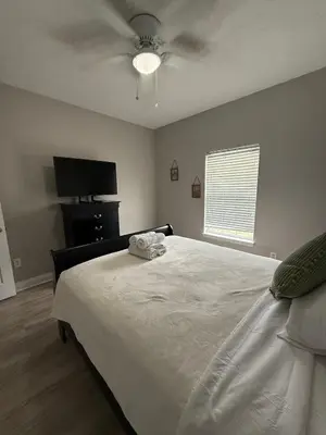a bedroom with a bed and a ceiling fan at Beach Days, Nightlife Nights, East End of PCB in Panama City Beach