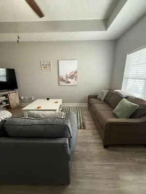 a living room with a couch and a table at Beach Days, Nightlife Nights, East End of PCB in Panama City Beach