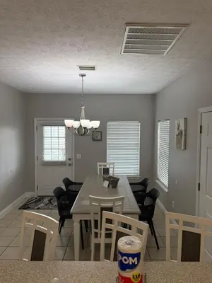 a dining room with a table and chairs at Beach Days, Nightlife Nights, East End of PCB in Panama City Beach