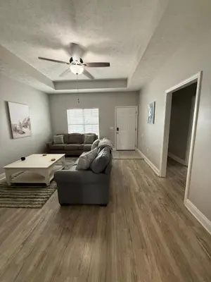 a living room with a couch and a table at Beach Days, Nightlife Nights, East End of PCB in Panama City Beach