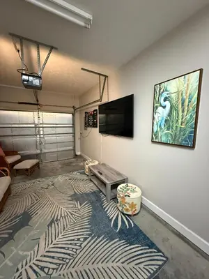 a living room with a flat screen tv on a wall at Beach Days, Nightlife Nights, East End of PCB in Panama City Beach