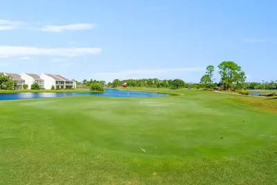 a view of the green at a golf course at Pet Friendly Beach House - Tropic Like It's Hot in Panama City Beach