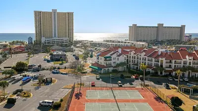 an aerial view of a city with a tennis court at Emerald Lagoon by AvantStay Bright Condo Pool Pier Tennis Access Walk to Beach Dining in Panama City Beach