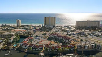 an aerial view of a resort next to the ocean at Emerald Lagoon by AvantStay Bright Condo Pool Pier Tennis Access Walk to Beach Dining in Panama City Beach