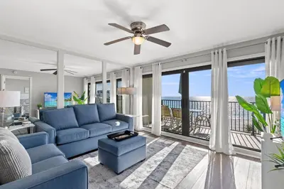 a living room with a couch and a ceiling fan at Commodore 0403 in Panama City Beach